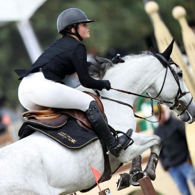 Emily Cinnamon Alvarez riding a horse. 